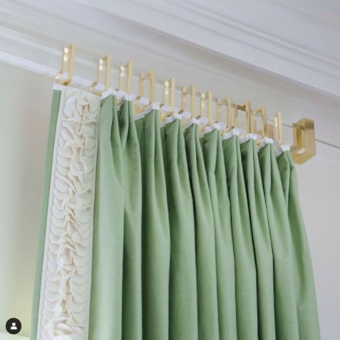 beautiful custom acrylic curtain rod with green curtains by jenkins interiors